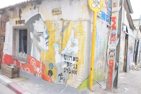 Graffiti and street art wrapping an old corner building in the Florentin quarter