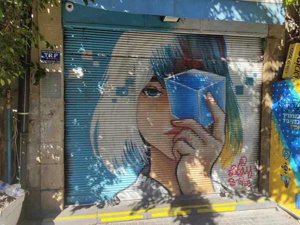 Painted shutter mural of a woman in the Noga flea-market quarter of Jaffa, Tel Aviv