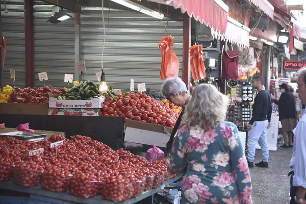 Tomato and vegetable stalls along a Carmel Market lane in the Yemenite Quarter of Tel Aviv