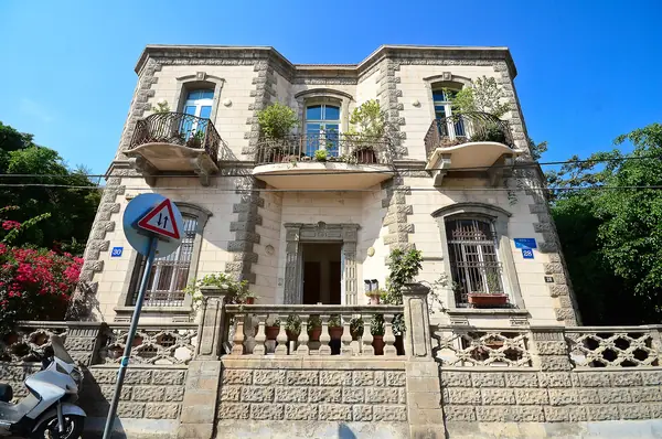 A grand restored Shalush mansion with balconies and greenery in Neve Tzedek, Tel Aviv